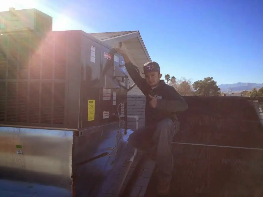 HVAC technician performing Heat Pump Repair on a rooftop unit in Shiloh
